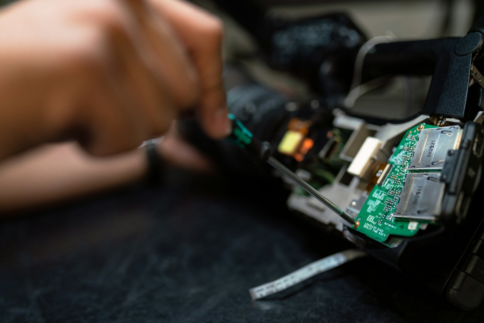 A person using a power drill on a wooden board